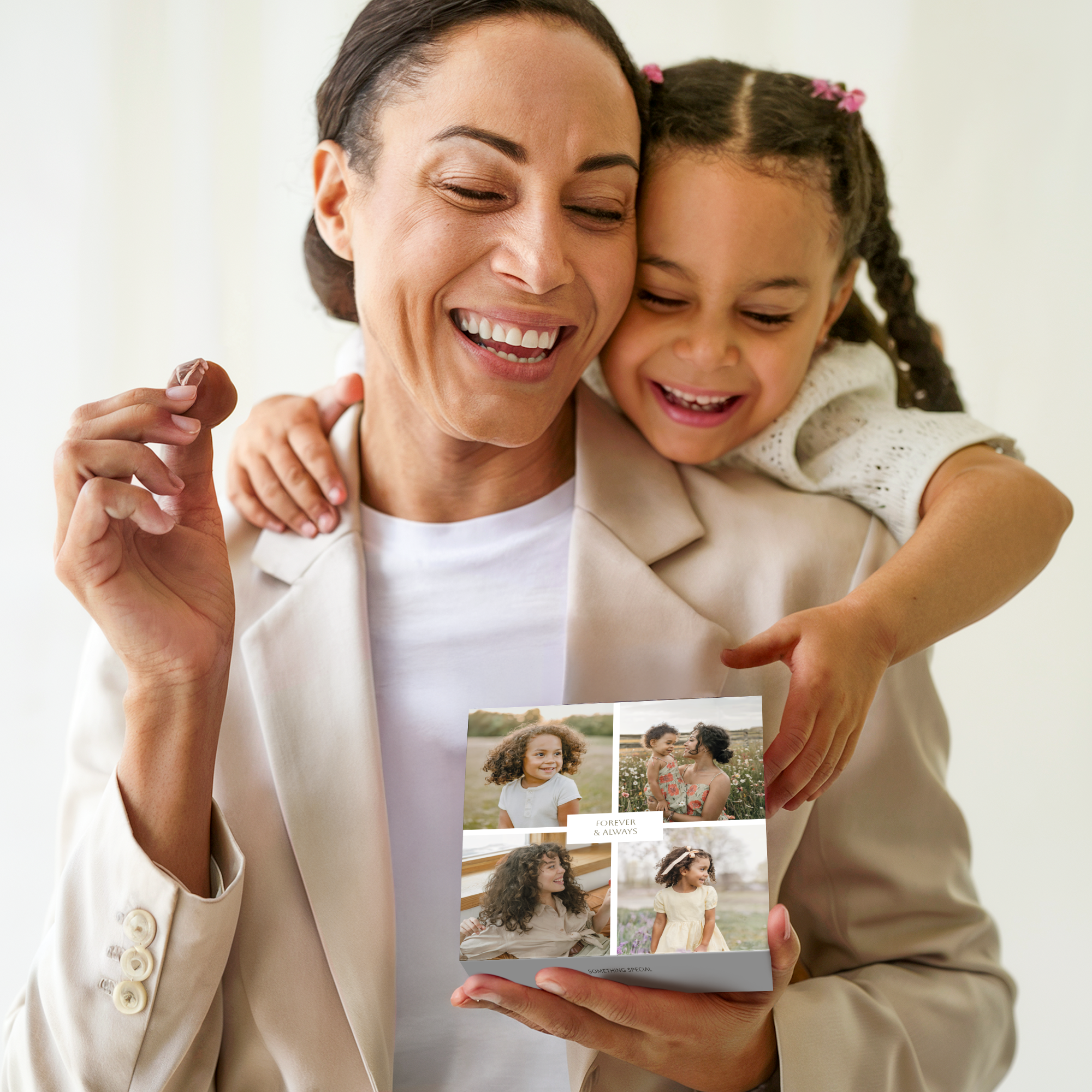 A mother and daughter smiling, holding a box of personalized deluxe chocolates printed with four different photos and the text Forever & Always.