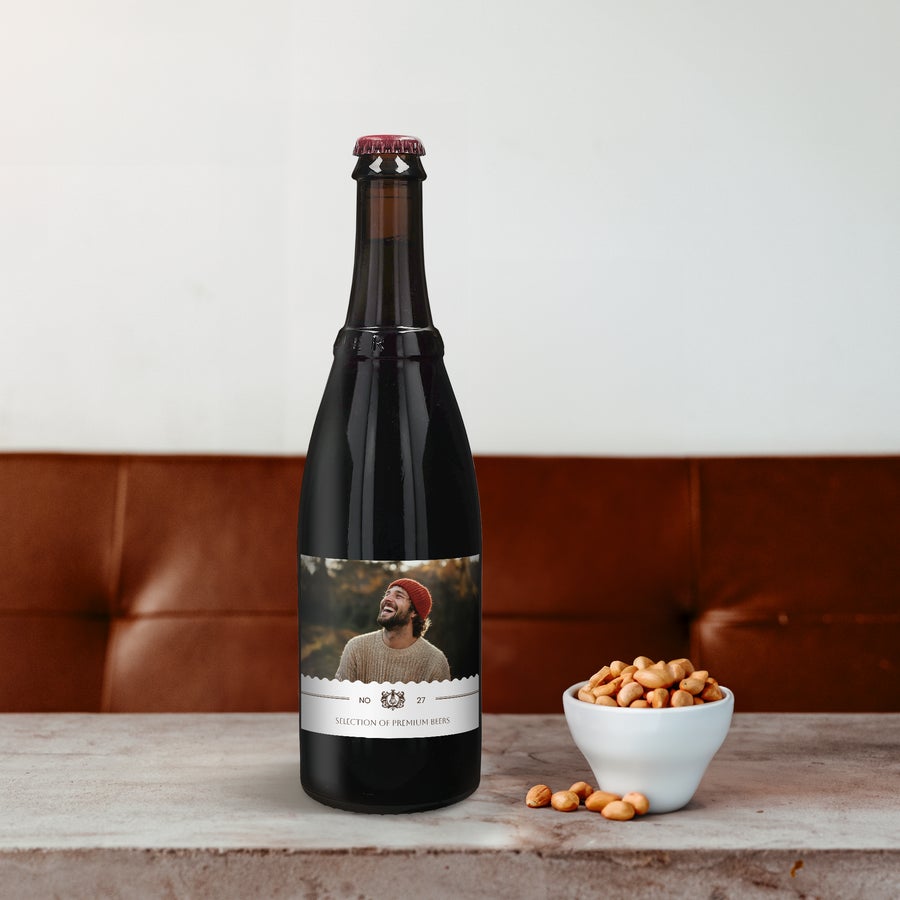 Personalised Beer Gift Box - Westmalle Dubbel & Tripel Dark Westmalle Dubbel beer bottle with a personalized label, printed with a man's photo, next to a bowl of peanuts.