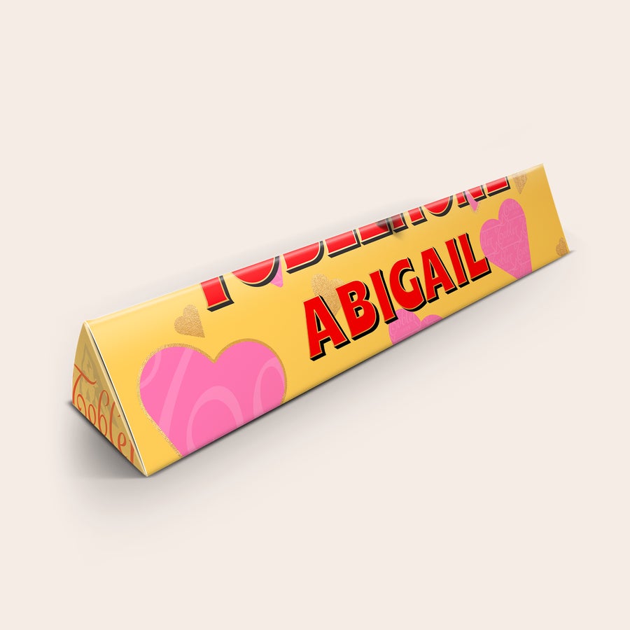 Toblerone Personalizzato - Amore Regala un dolcissimo Toblerone personalizzato con nome Abigail stampato e cuori rosa e oro