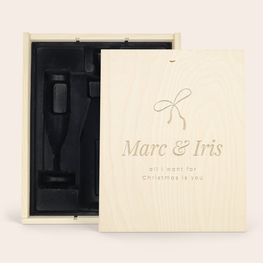 Personalised Champagne Case A deluxe wooden case with engraved names Marc & Iris and "all I want for Christmas is you", with black inlay for a bottle and 2 champagne glasses