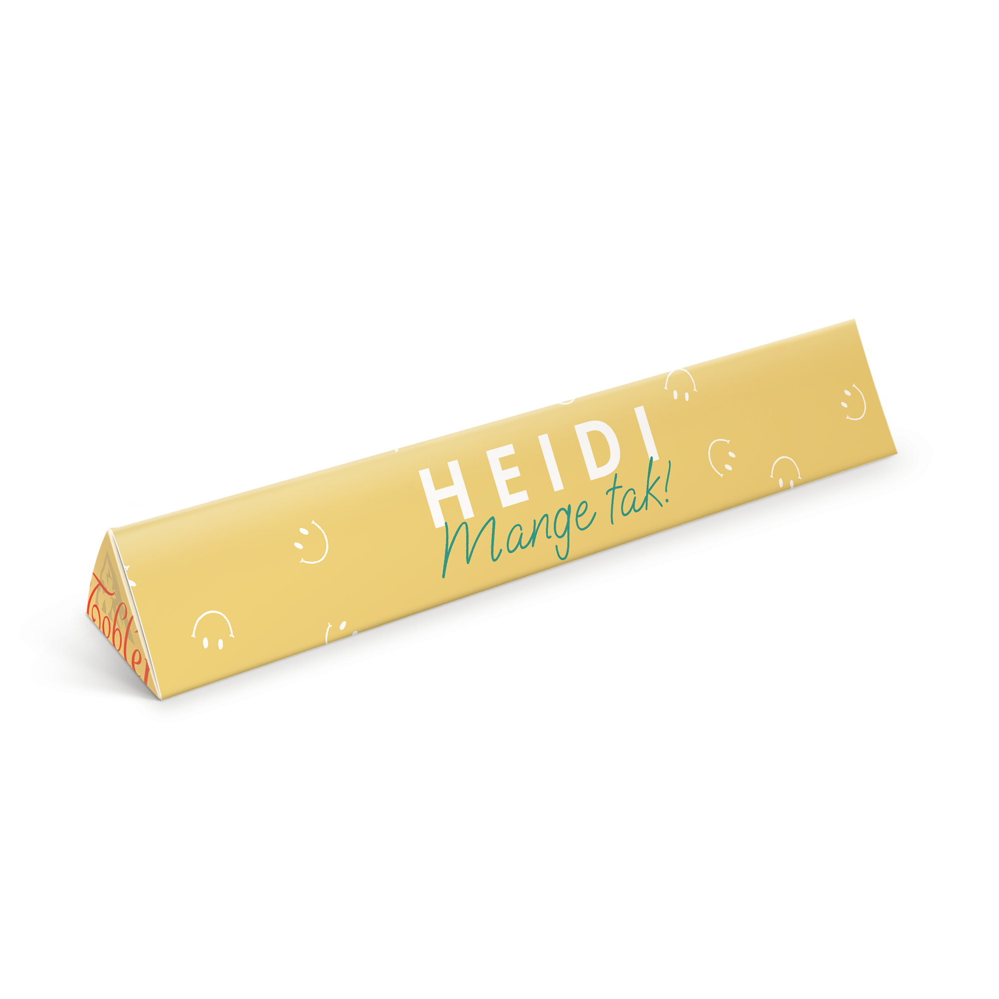 En personlig Toblerone chokolade med gult omslag trykt med navnet HEIDI og teksten "Mange tak!"