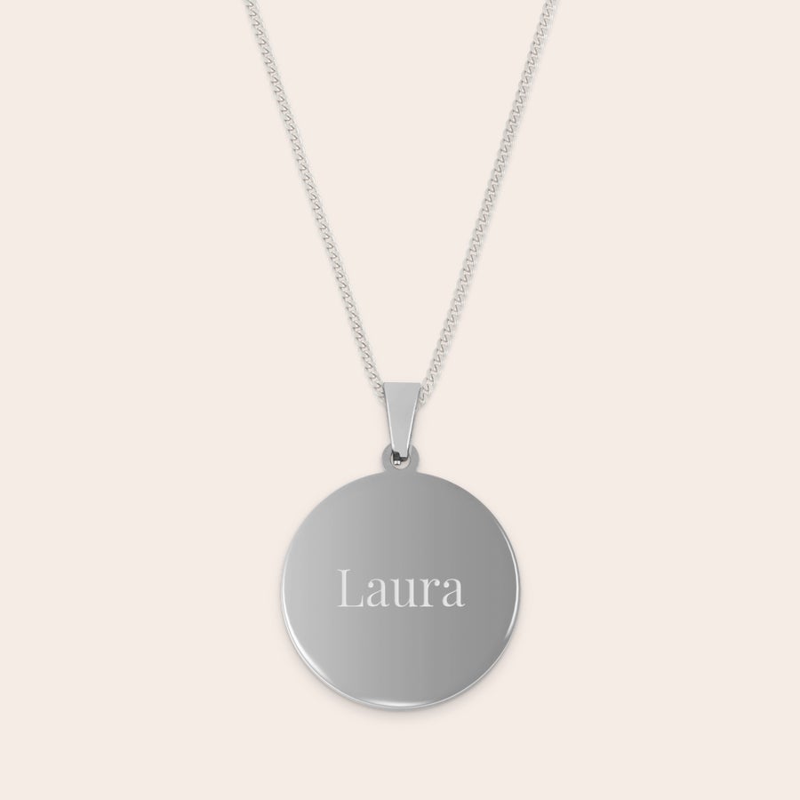 Round pendant necklace Silver rhodium pendant with Laura engraved on the front, attached to a chain. Give an engraved pendant with a name.