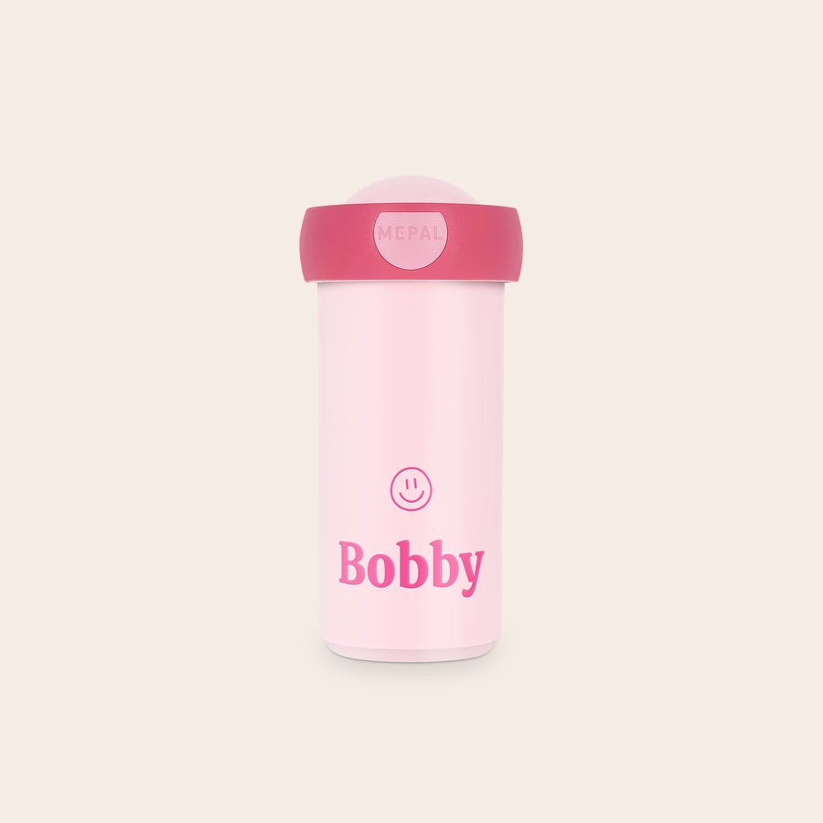 Vaso escolar personalizado - Mepal Taza escolar personalizada rosa con el nombre Bobby y una cara sonriente impresa, perfecta para el día a día.