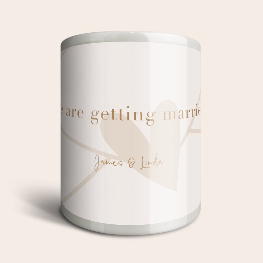 Personalised money box Personalised money box with "we are getting married James & Linda" printed on a light background with a heart design.