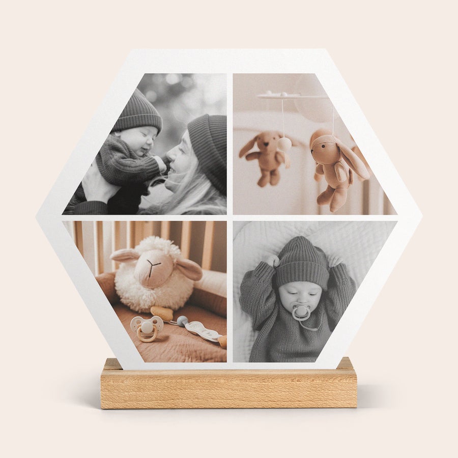 Wooden Photo Tile A hexagonal forex photo tile printed with four black and white baby photos, displayed on a wooden stand