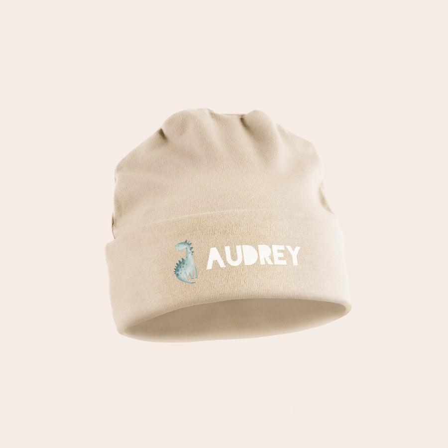 Bonnet naissance personnalisé Bonnet bébé beige personnalisé avec le prénom Audrey et un motif dinosaure imprimés