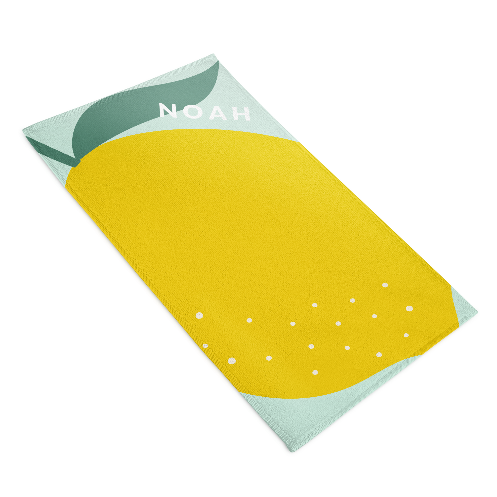 Toalha de praia amarela com estampa de limão e nome NOAH, personalizada para surpreender estas férias.