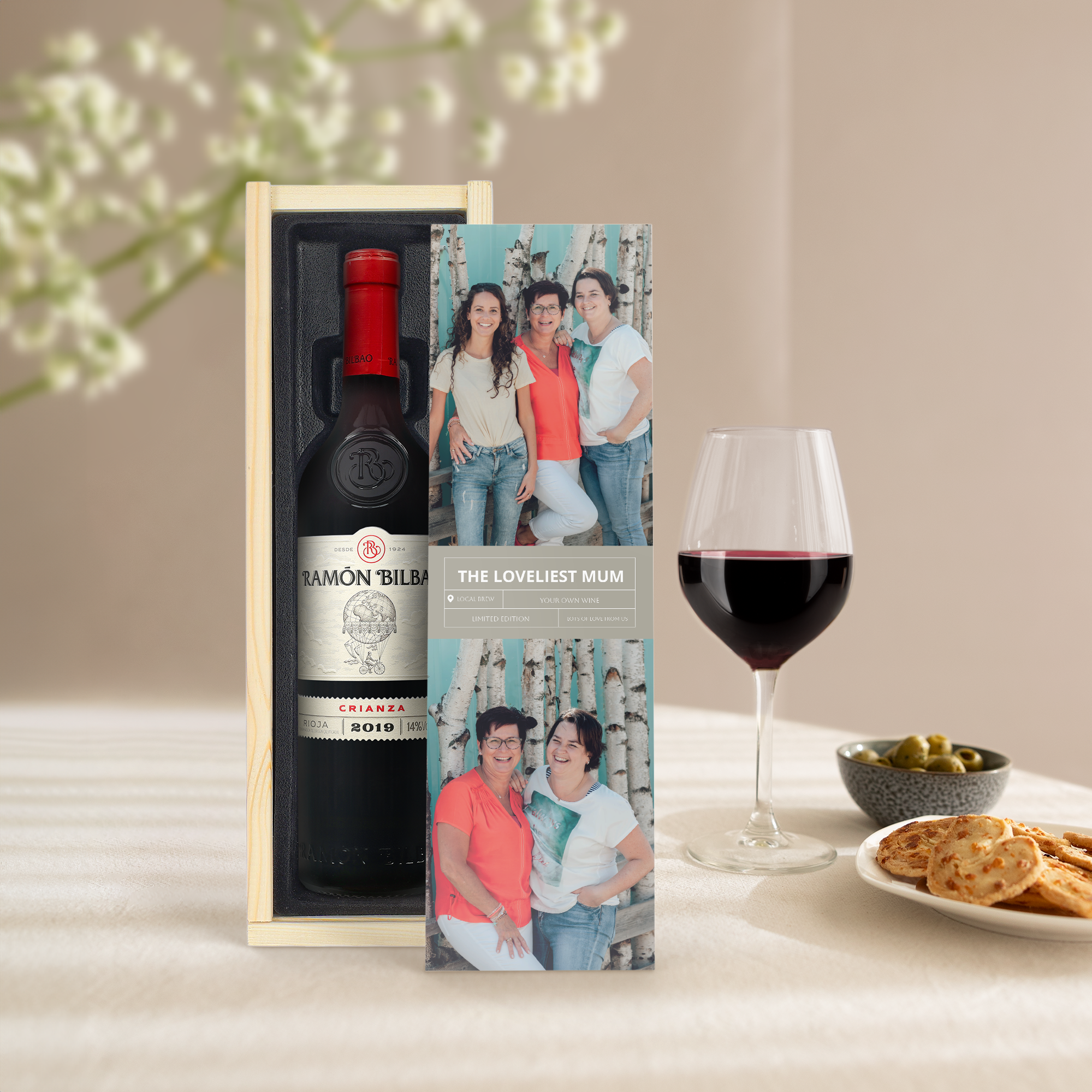 A bottle of Ramon Bilbao Gran Crianza red wine in a personalized wooden case, printed with photos and text reading The Loveliest Mum.