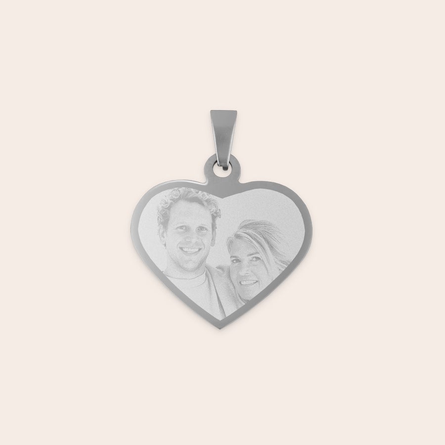 Engraved heart necklace Heart-shaped rhodium pendant engraved with a photo of a couple smiling.