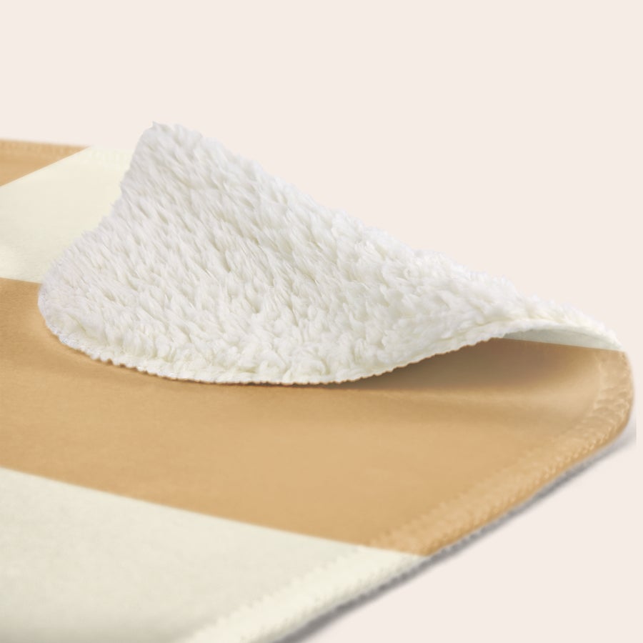 Personalised photo blanket Fleece blanket detail showing fluffy white texture and tan striped pattern, a personalised fleece blanket.