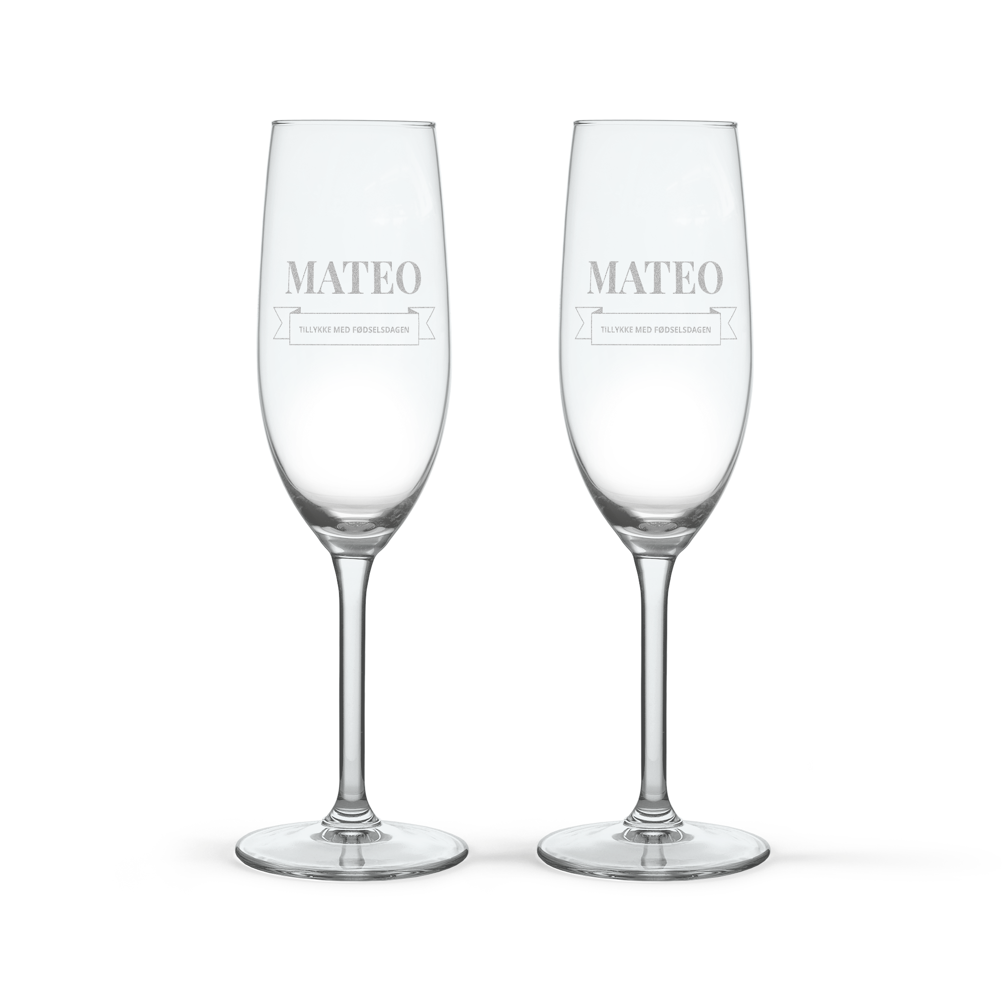 To champagnepakker med indgraveret låg og personlige glas med teksten Mateo Tillykke med fødselsdagen. Skål!