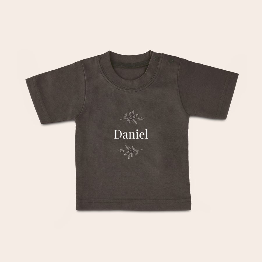 Personalised baby t shirt Dark gray baby shirt with name Daniel printed with white text and leaf design