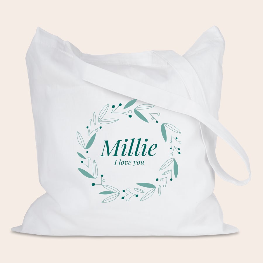 Muleposer med tryk Hvid økologisk mulepose med grønt bladkransdesign og navnet Millie trykt i midten