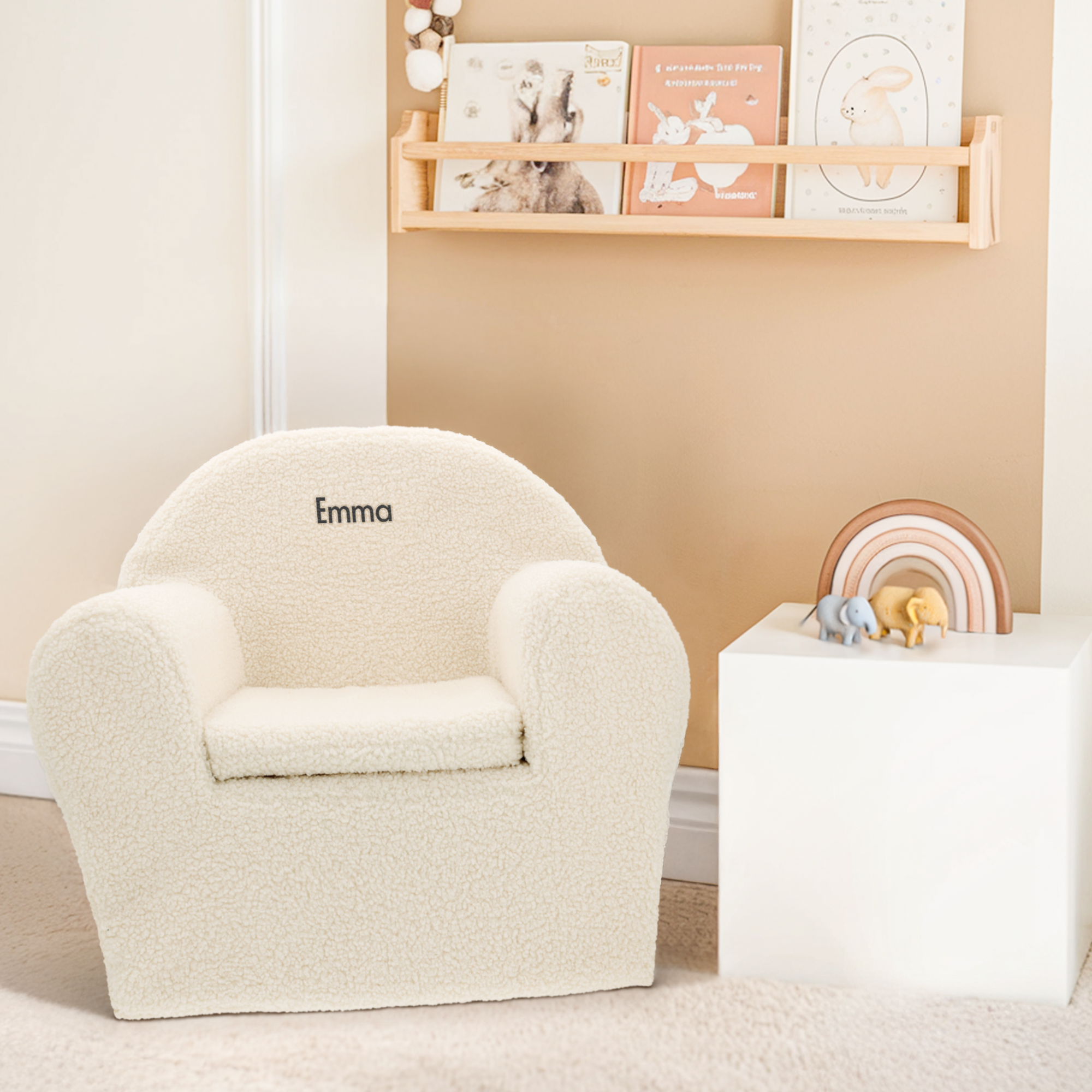 Cadeira de pelúcia infantil personalizada off-white, com o nome "Emma" bordado em preto.