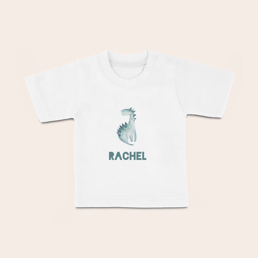 T shirt bébé personnalisé T-shirt bébé blanc imprimé d'un dinosaure et du prénom Rachel, un bout'chou ultra-tendance