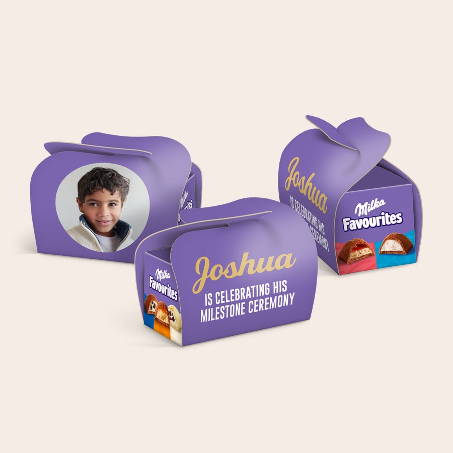 Milka Favourites többcsomagos ajándékok – személyre szabott Lila Milka Favourites csokoládés dobozok személyre szabott fotóval és arany Joshua névvel, felirattal: "IS CELEBRATING HIS MILESTONE CEREMONY".