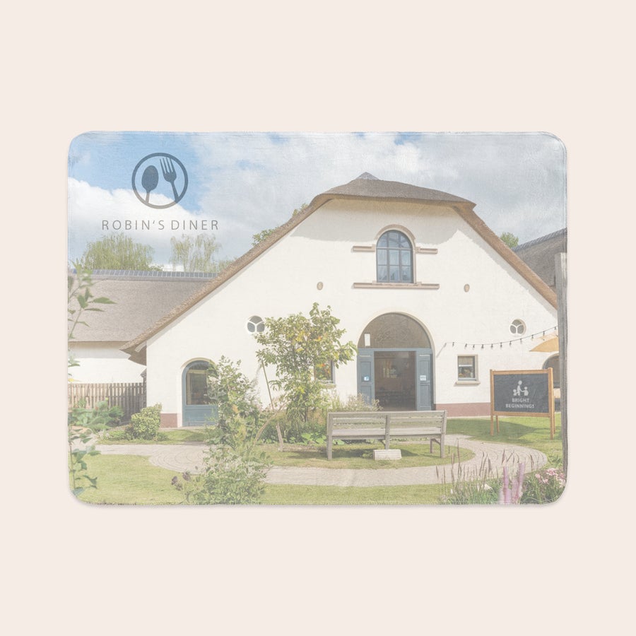 Personalised photo blanket Fleece photo blanket printed with an image of Robin's Diner, a white building with a thatched roof.