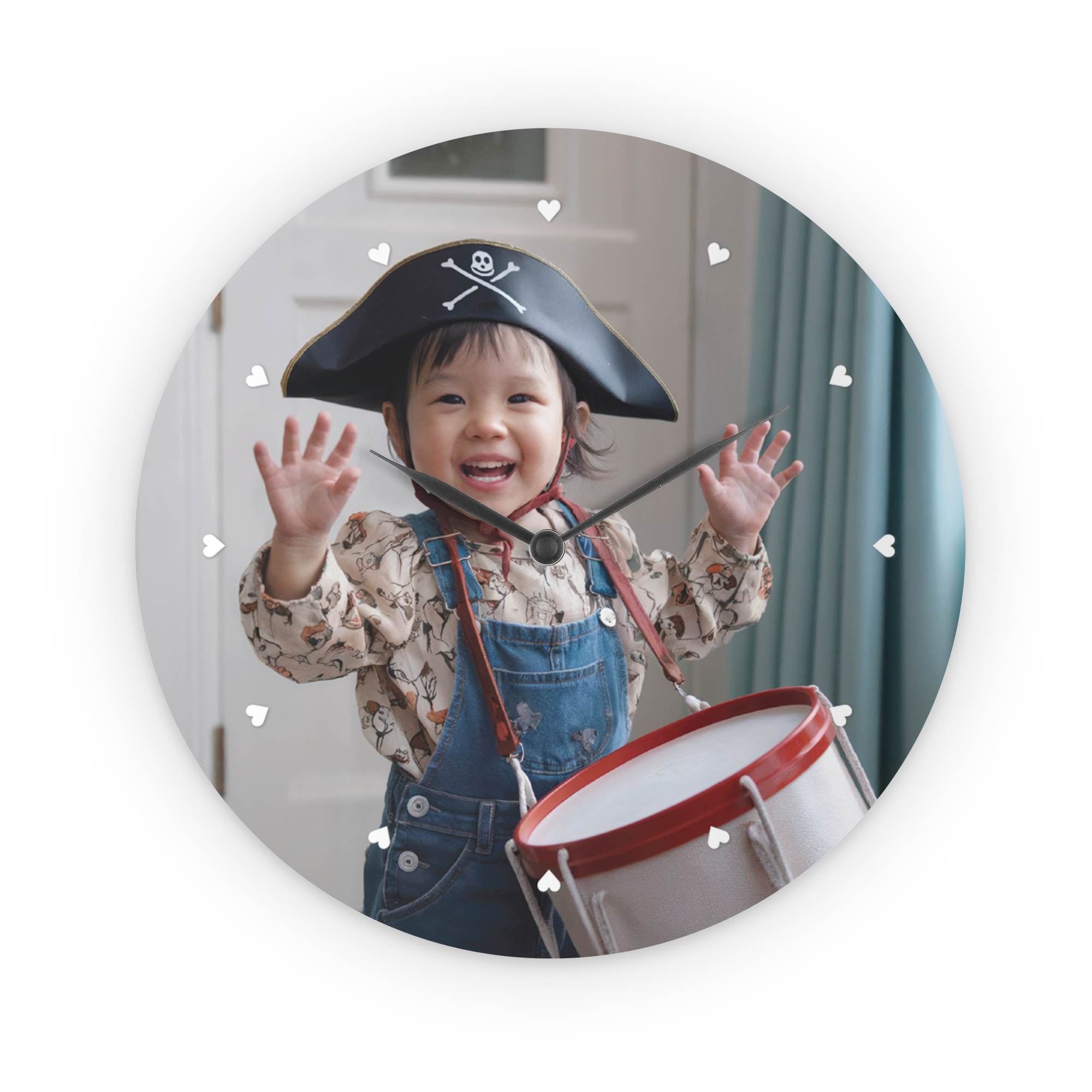 A personal clock printed with a photo of a happy child in a pirate hat playing a drum.