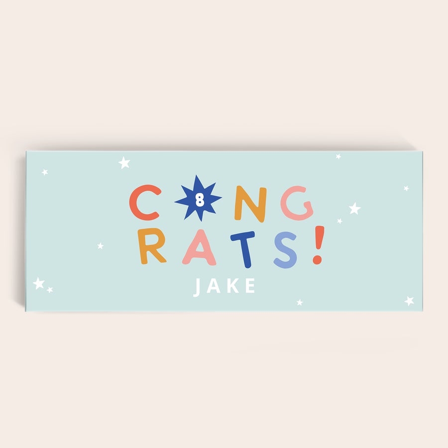 Personalizowana Mega Milka Ta tabliczka czekolady XXL z napisem CONGRATS i imieniem JAKE, z numerem 8 wydrukowanym na opakowaniu.