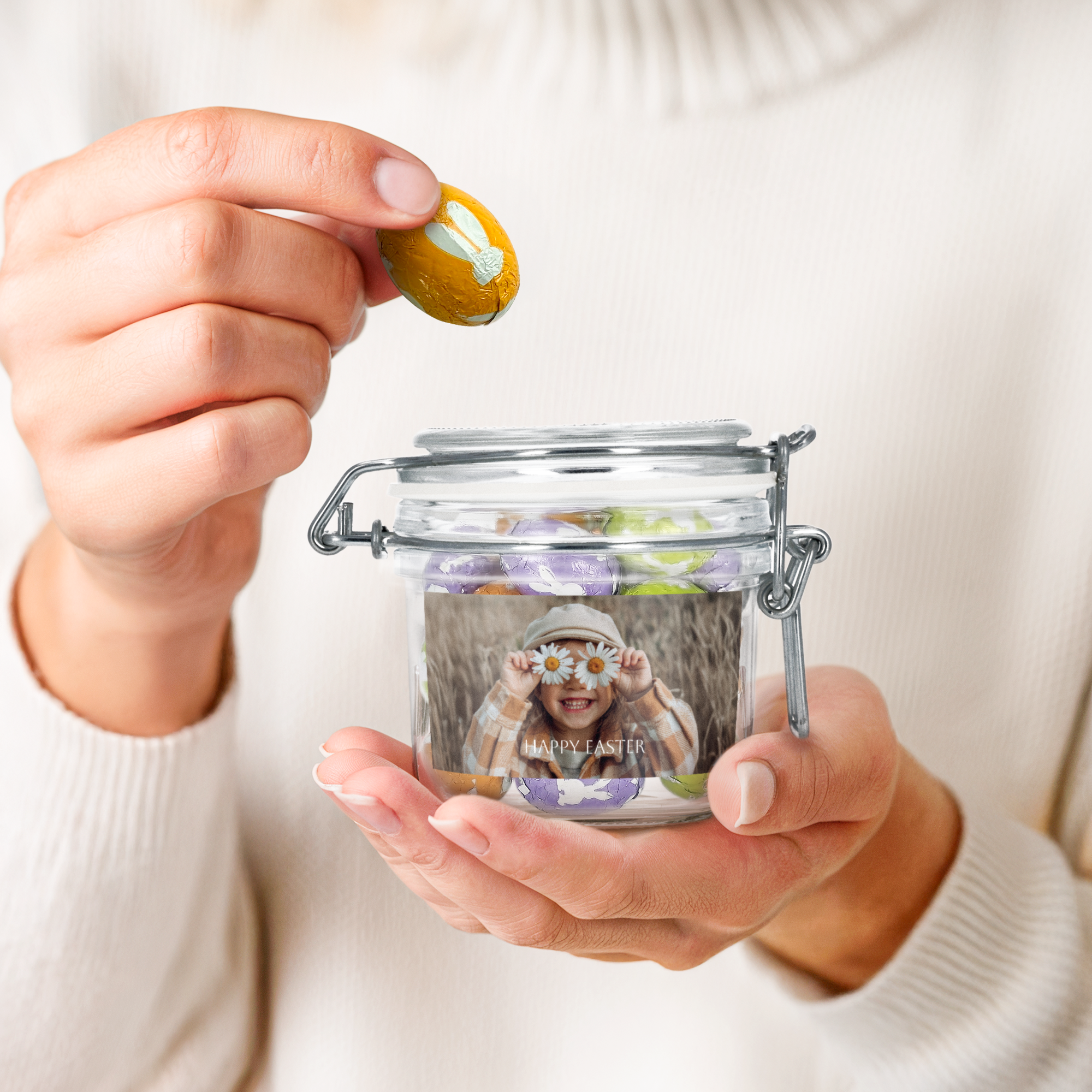 Personalised sweet jar - 200 ml - Chocolate eggs with a custom photo and "Happy Easter" text, held by hands.