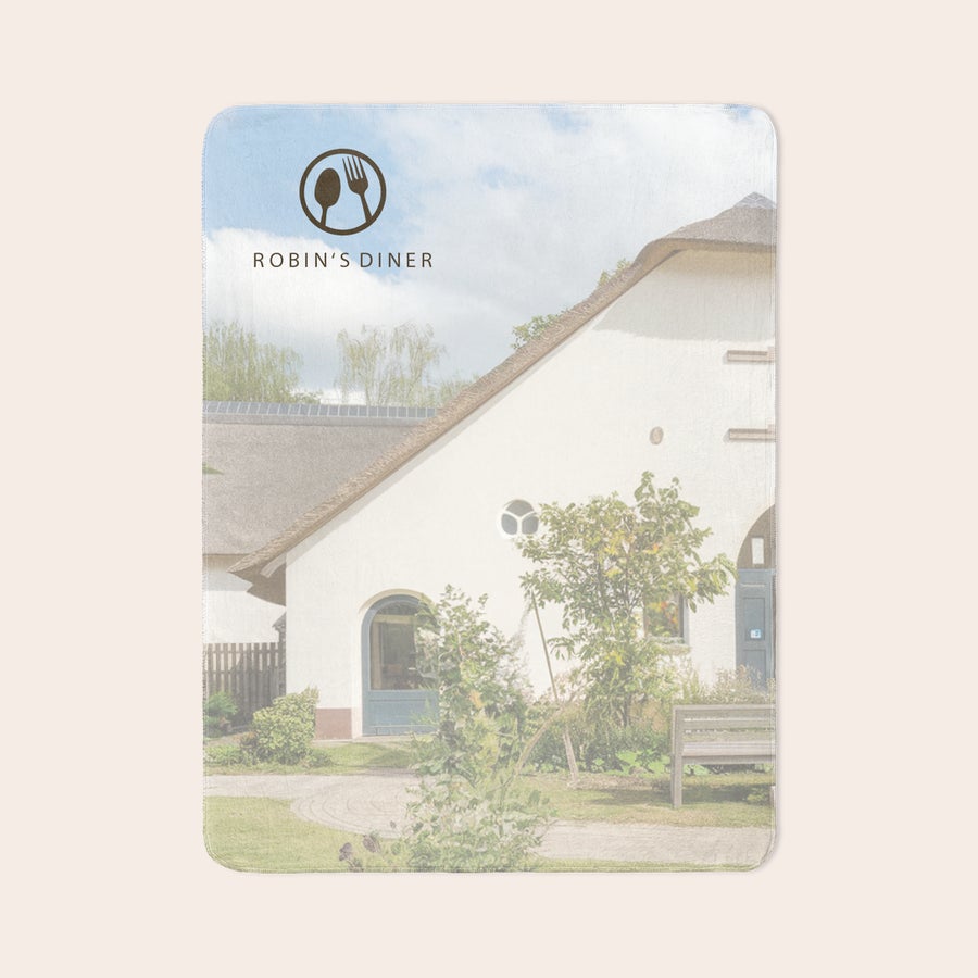 Personalised photo blanket Custom fleece photo blanket printed with an outdoor scene featuring a white house, green foliage, and blue sky, with a "Robin's Diner" logo at the top.