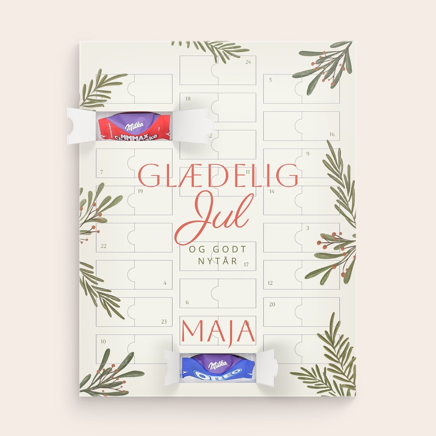 Chokolade Julekalender - Milka Favourites Personlig chokolade julekalender med Milka chokolade, designet med grønne grene og teksten "Glædelig Jul og Godt Nytår", samt navnet Maja.