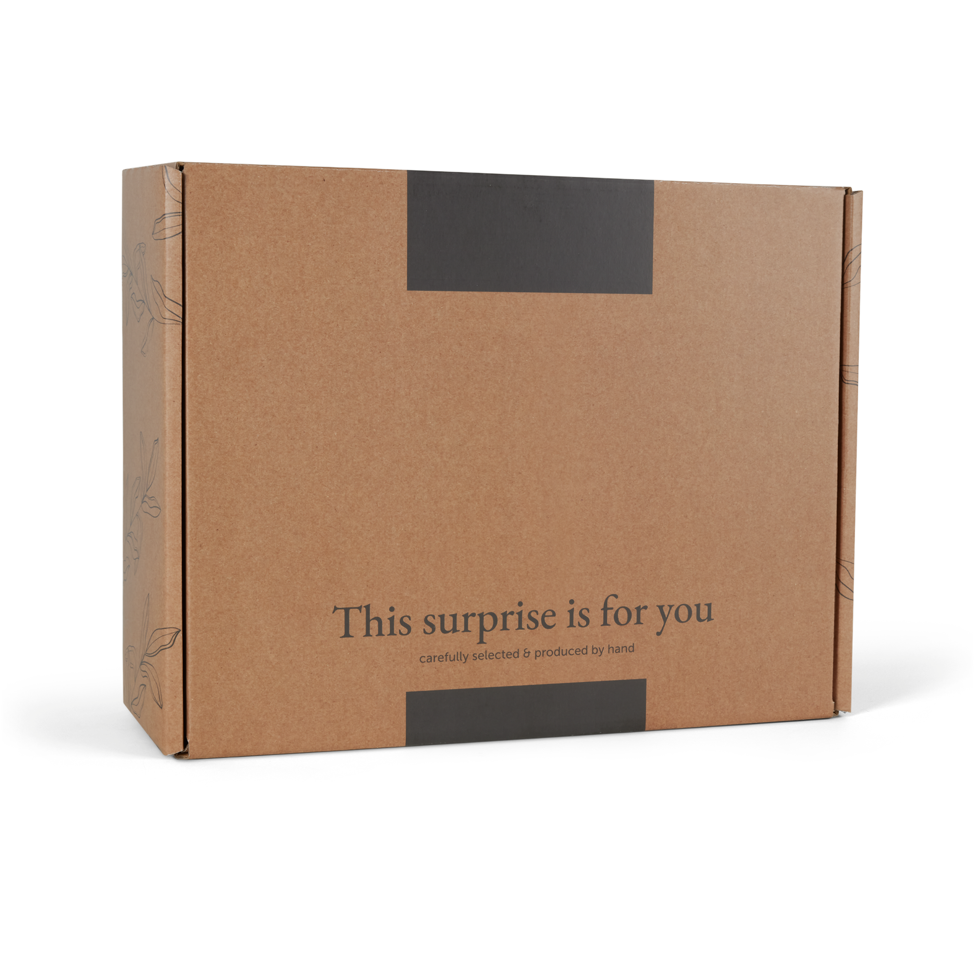 Caja de regalo marrón con el texto This surprise is for you, cuidadosamente seleccionada y producida a mano.