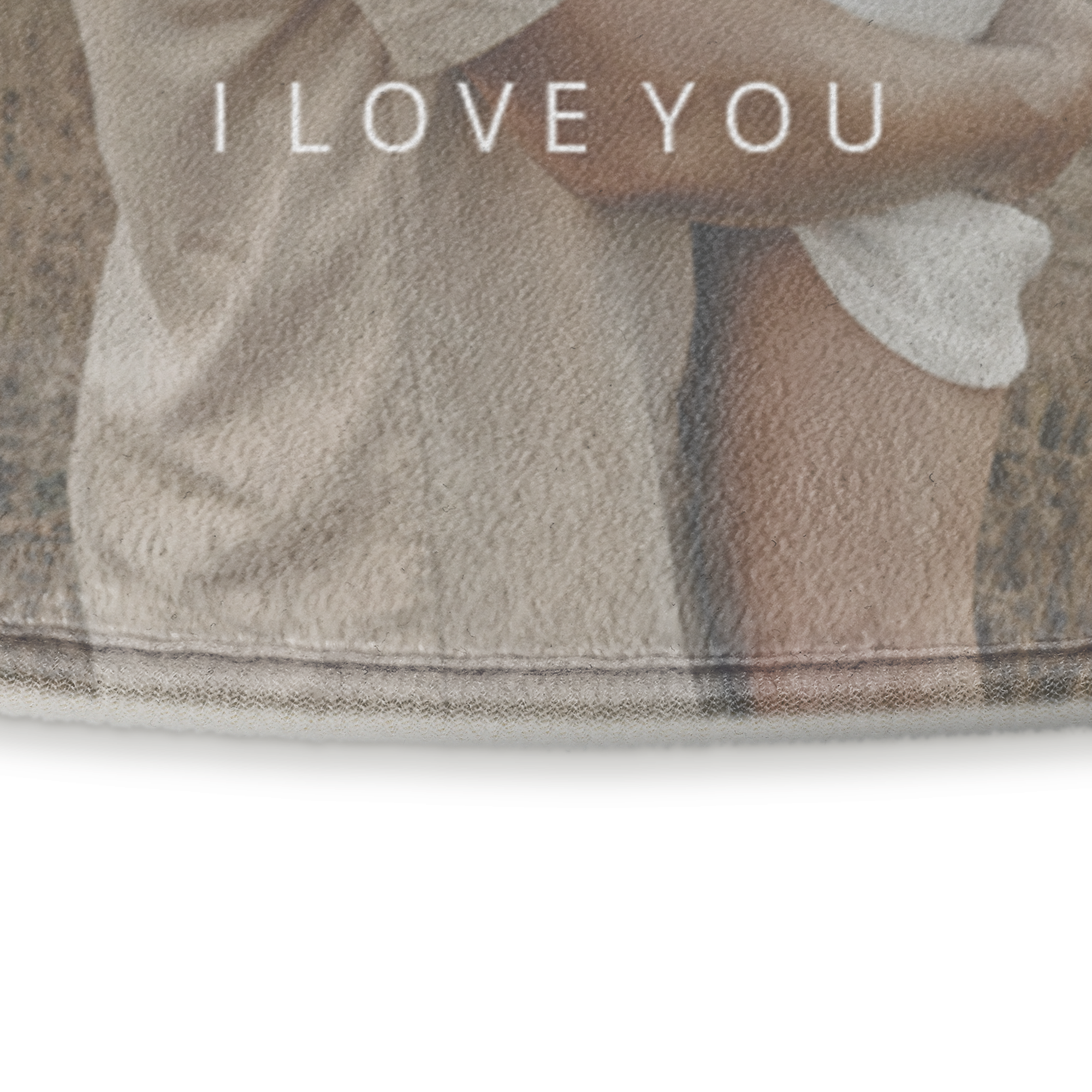 A close-up of a personalized bath mat with a printed "I LOVE YOU" message over a soft fabric.