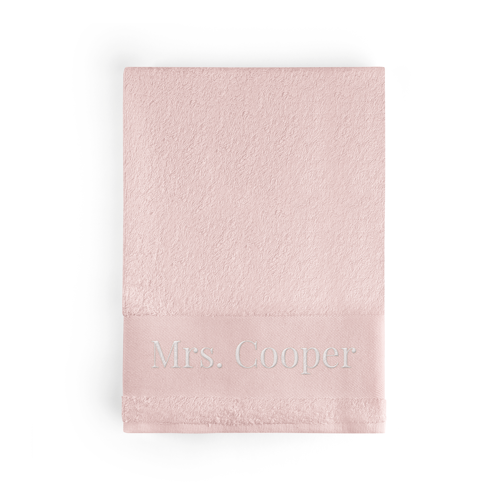 A personalised pink bath towel with the name Mrs Cooper embroidered in white thread.