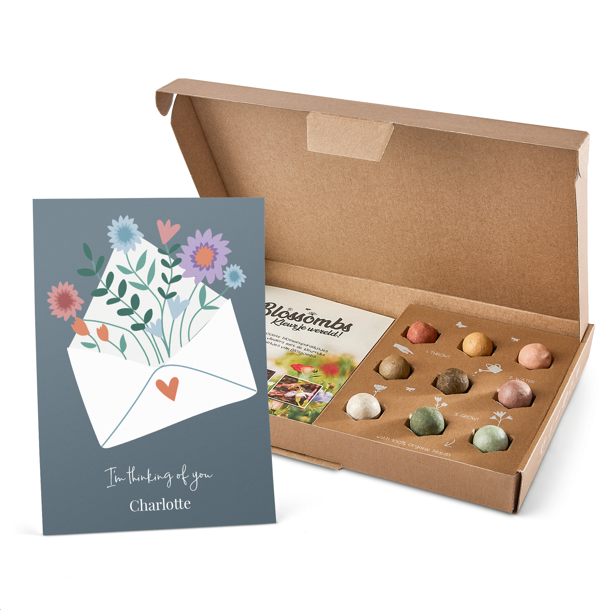 Scatola regalo esplosiva con biglietto personalizzato con fiori in busta e testo "I'm thinking of you Charlotte", include bombe di semi e istruzioni