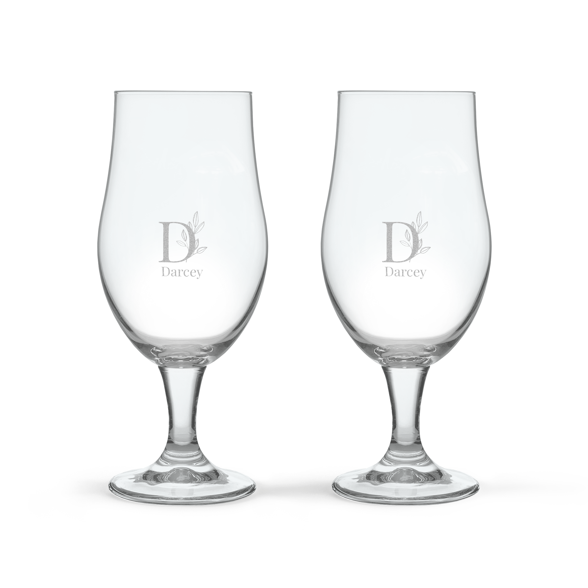 Two personalized beer glasses, each engraved with a capital D and the name Darcey.