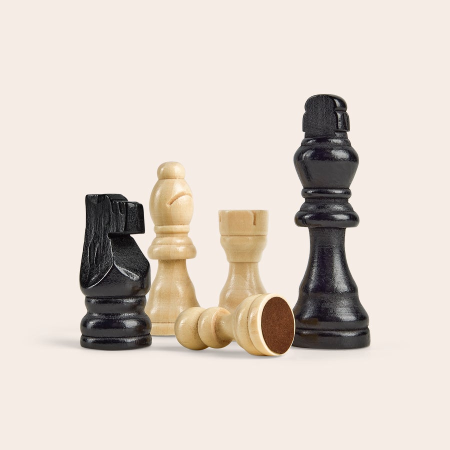 Chess game Personalized chess set with a black knight, king, and pawn, and light wood bishop, rook, and fallen pawn, ready for your custom design.