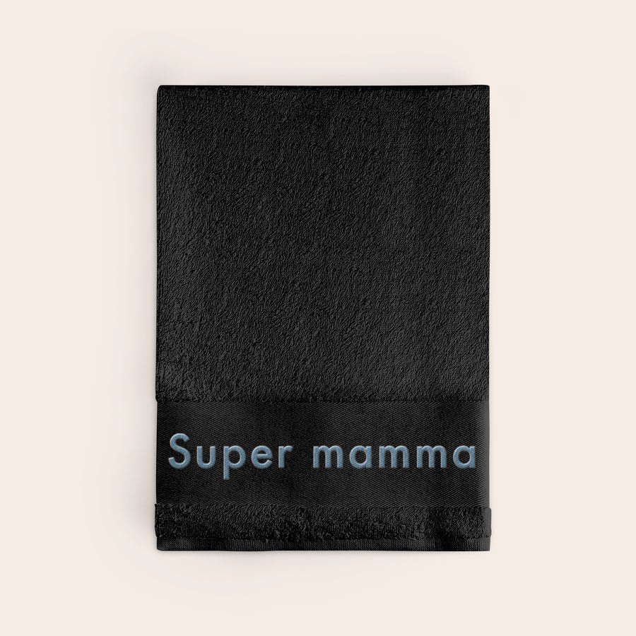 Badhandduk med text Svart badhandduk i bomull med texten Super mamma broderad i blå tråd, en personlig badhandduk.