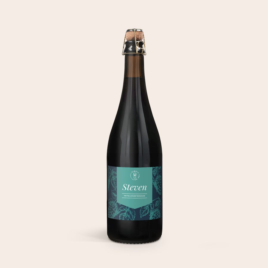 Personalised Beer - Cuveé du Chateau Dark beer bottle with a personalized teal and navy label printed with the name Steven and "For the loveliest bonus dad."