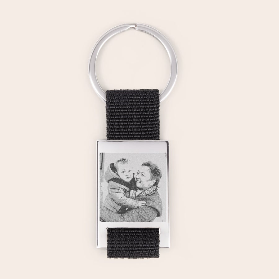 Engraved keyring Deluxe keyring with a silver finish, black strap, and an engraved photo of a woman holding a child
