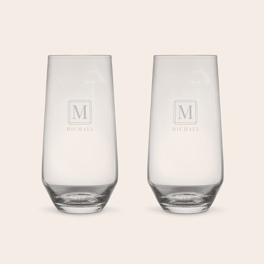 Vasos de agua personalizados Dos vasos de agua de cristal con un grabado láser de la inicial M enmarcada y el nombre MICHAEL debajo para regale un nuevo recuerdo nítido.