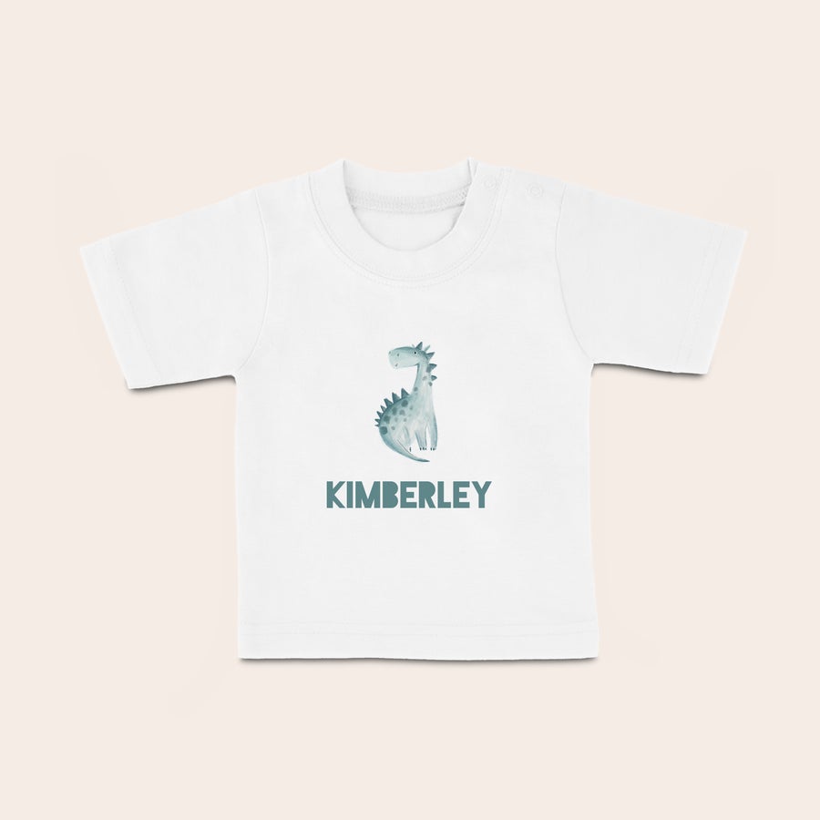 Baby t shirt bedrucken Weißes Baby T-Shirt mit einem gezeichneten Dinosaurier und dem Namen KIMBERLEY, mit einem Namen bedruckt