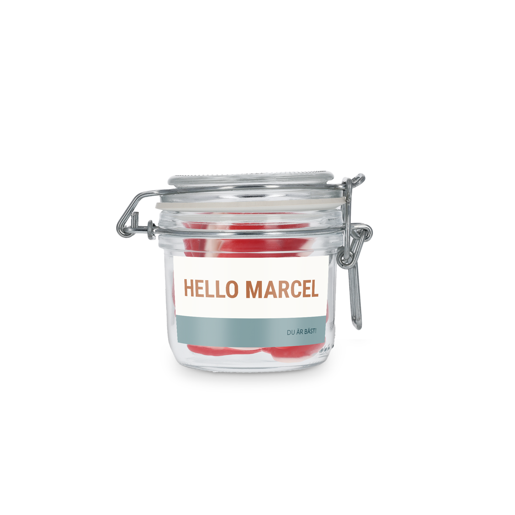 Personlig sötburk med hjärtan, fylld med röda gelégodisar. Etiketten är tryckt med texten Hello Marcel och Du är bäst.