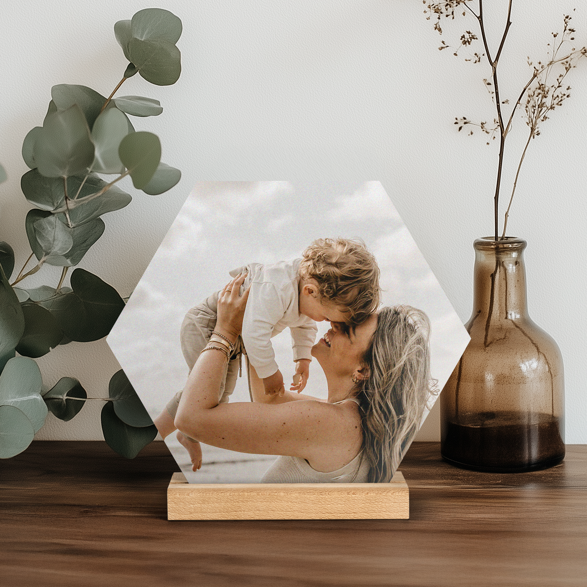 Hexagonal Forex photo tile printed with a personalized photo of a mother and child, displayed on a wooden stand