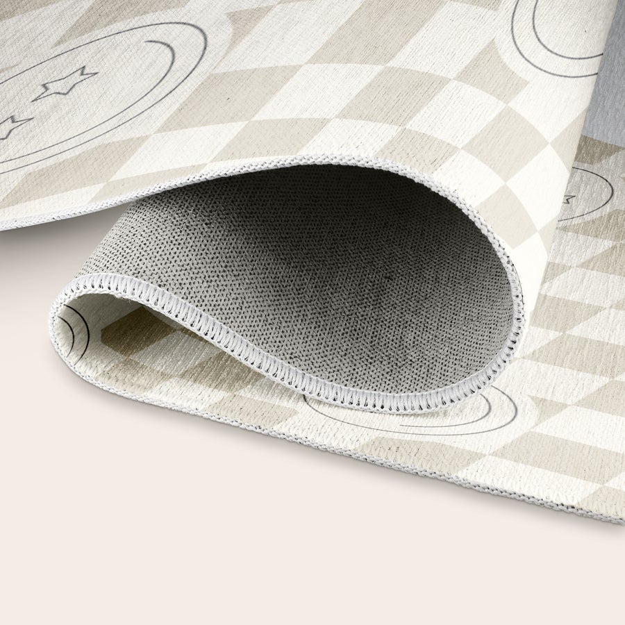 Printed Play Mat Rolled up personalized play mat with a checkered pattern and stars printed on it, showing the textured base