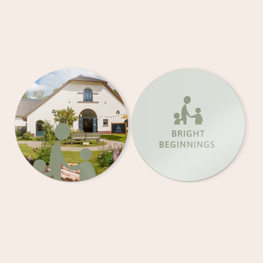 Panouri de perete personalizate Două panouri decorative rotunde personalizate. Unul imprimat cu o casă și natură, celălalt cu un logo și textul BRIGHT BEGINNINGS. Decorează-ți peretele cu panouri decorative din lemn.
