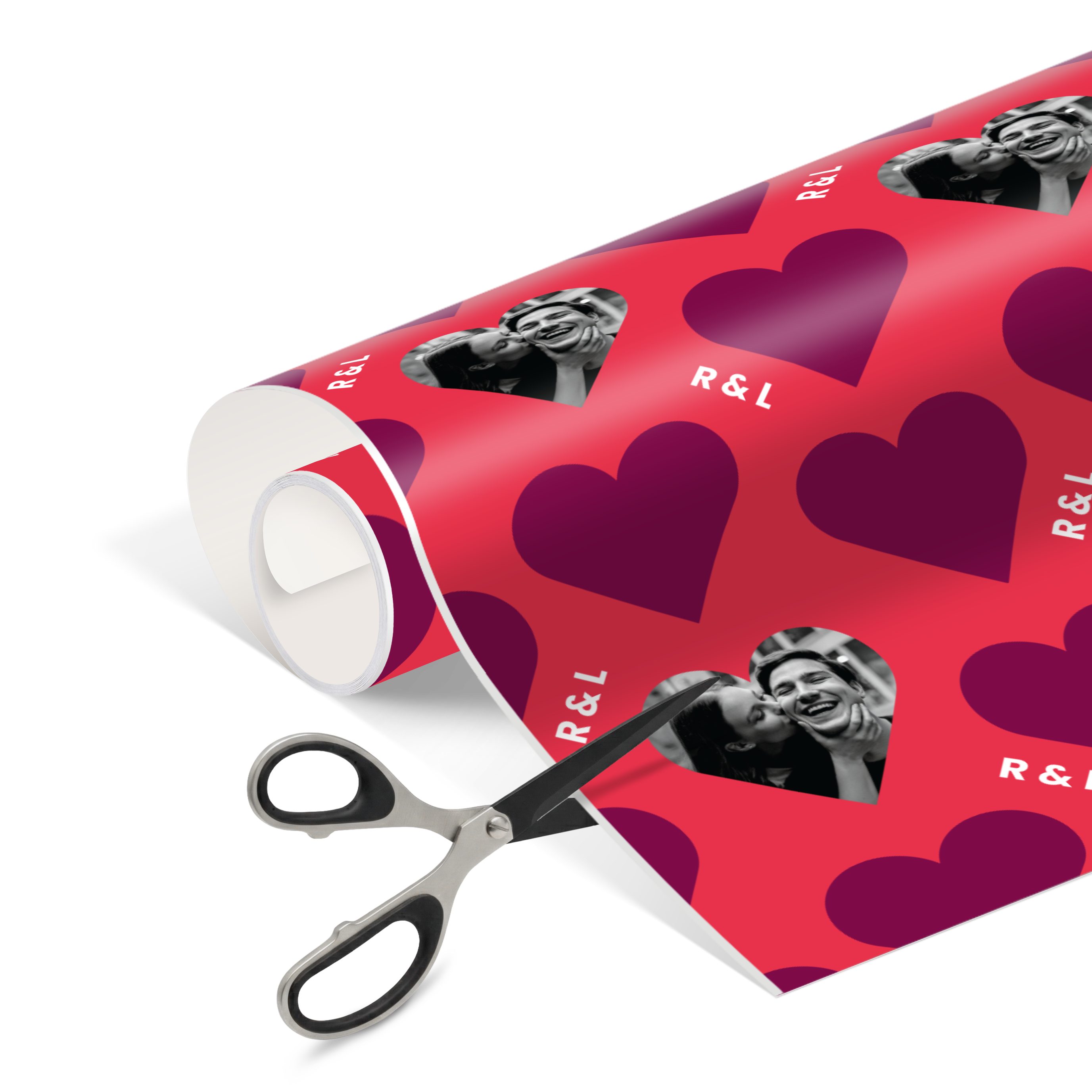 Red personalised wrapping paper with purple hearts and custom printed photos of a couple, plus custom R&L initials.