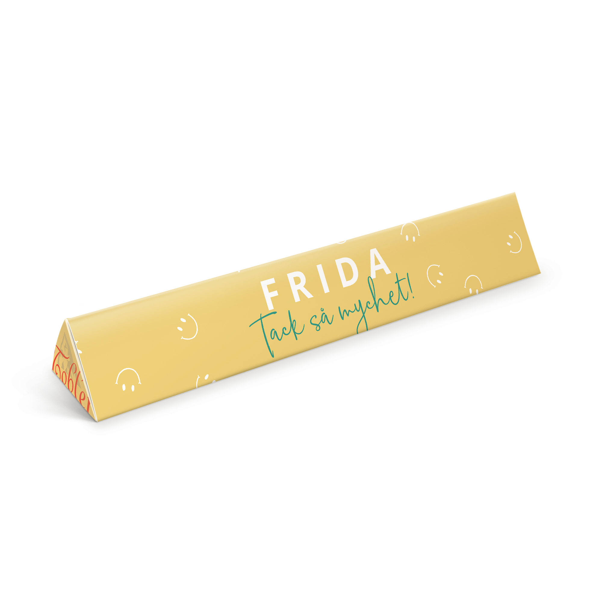 Personlig Toblerone i gul förpackning med tryckt text Frida och Tack så mycket samt små leende ansikten. En personaliserad Toblerone är betydligt godare.