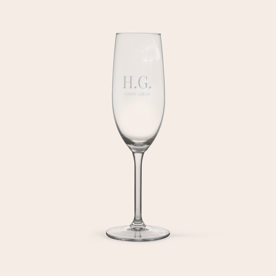 Personalised champagne glasses Elegant personalised champagne flute engraved with initials HG and the name HARRY GREEN