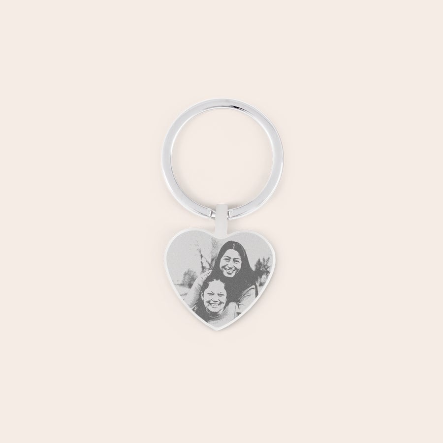 Engraved keyring Silver heart-shaped keyring engraved with a personalized photo of two women smiling