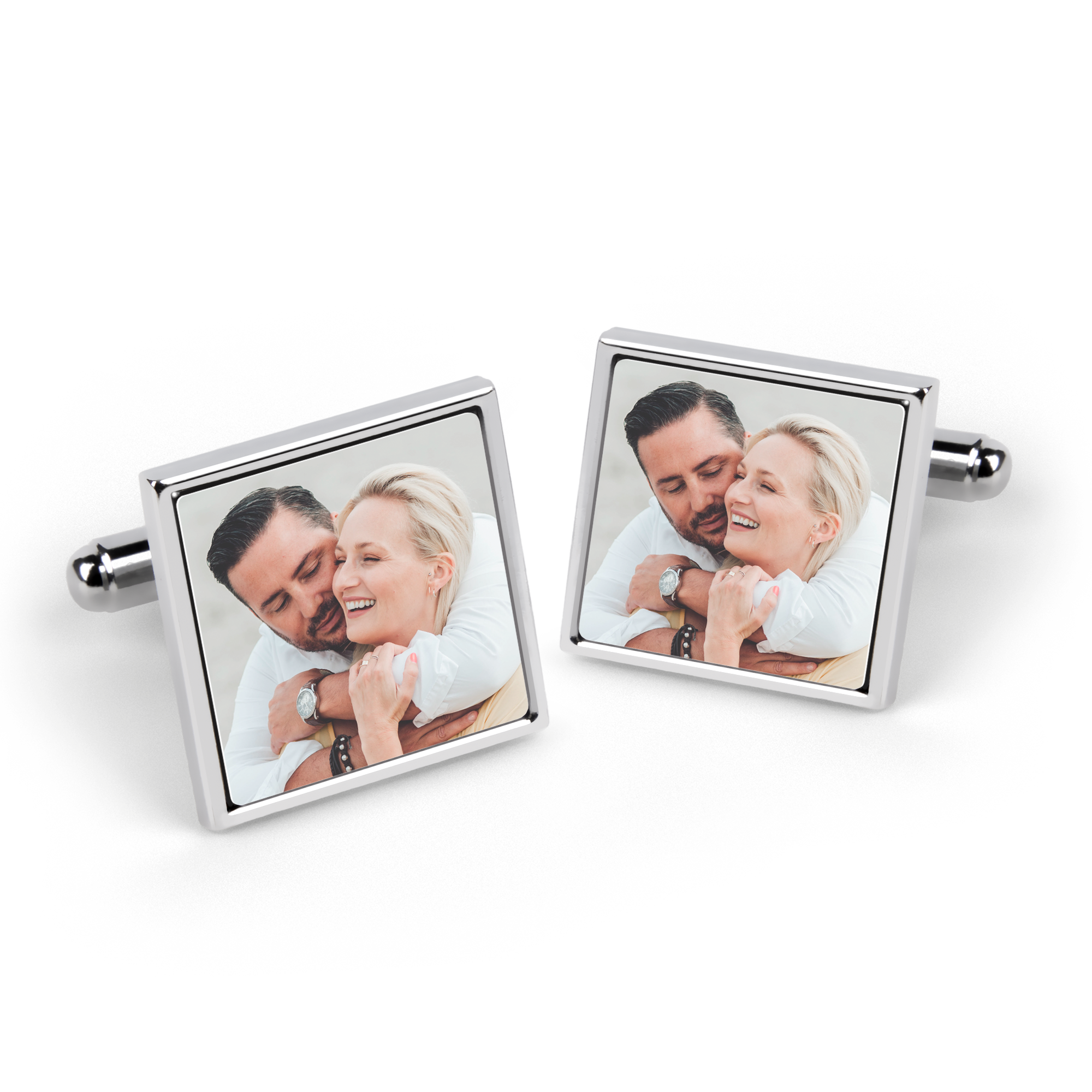 Pair of silver square cufflinks, each printed with a photo of a man hugging a woman. Surprise your loved ones with personalized photo cufflinks.