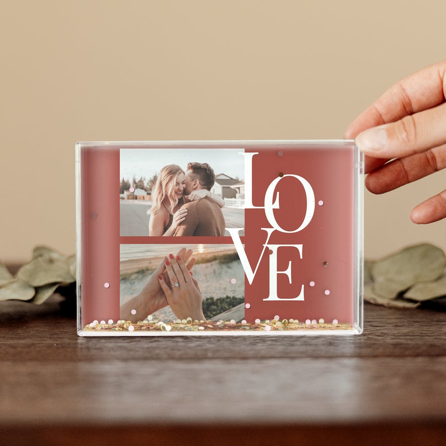 Schneekugel Personalisiert Personalisierte Schneekugel mit Herzen, gedruckt mit zwei Fotos eines Paares und dem Wort LOVE.