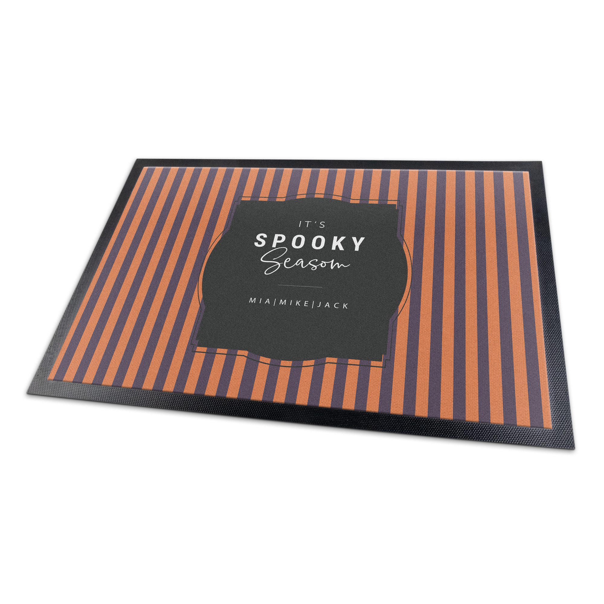 A personalized doormat with orange and purple stripes and text printed with "It's Spooky Season" and names Mia Mike Jack.