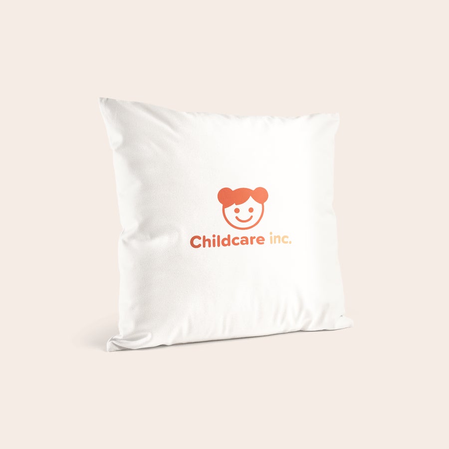Personalised cushions & cushion cases White personalized cushion with an orange printed logo showing a smiling child's face and the text "Childcare inc."
