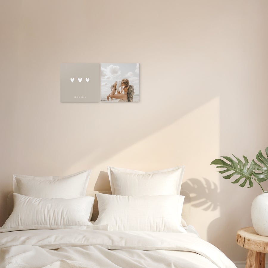 Personalised wall art panels Two custom wooden wall art panels, one printed with three white hearts and a date, the other with a family photo.